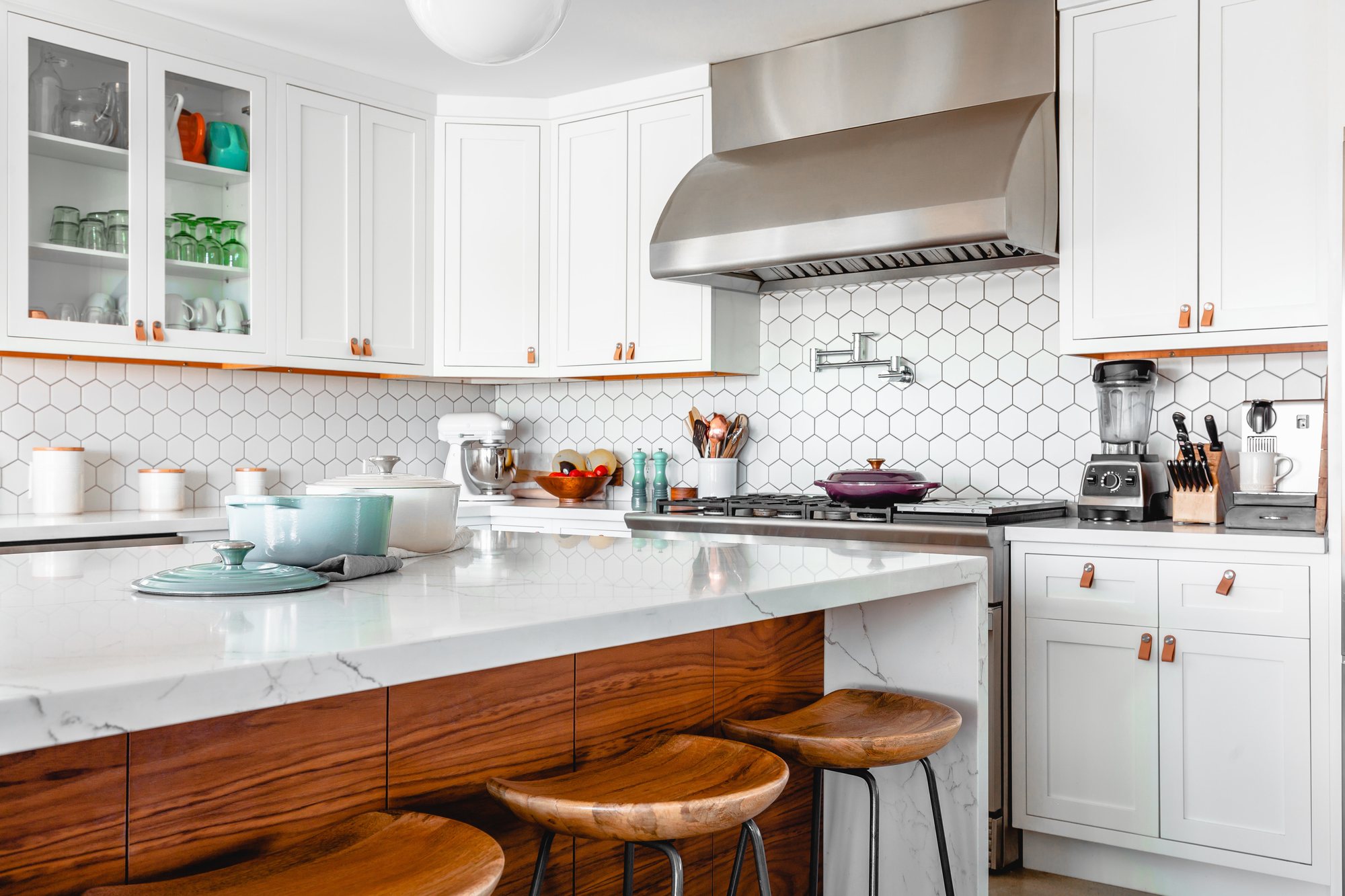 Kitchen with hexagon backsplash, walnut island and stainless hood