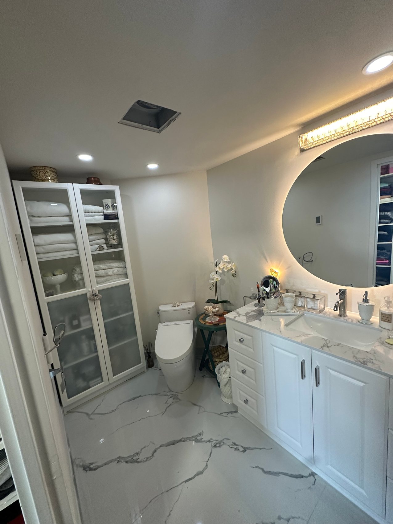 Frameless glass shower - Marble vanity · Patterned floor
